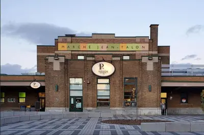 a building with a clock on the front of it at Stylish 1-Bedroom Haven by Jean Talon Market in Montréal