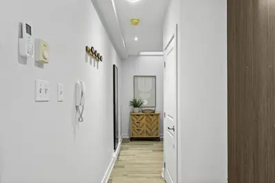 a hallway with white walls and a hallway with a door at Stylish Open-Space Studio by Jean Talon Market in Montréal