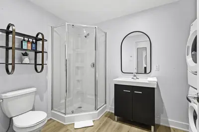 a bathroom with a shower and a toilet and a sink at Stylish Open-Space Studio by Jean Talon Market in Montréal