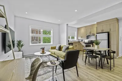 a living room with a couch and a table at Stylish 2 Bedroom Haven by Jean Talon Market in Montréal