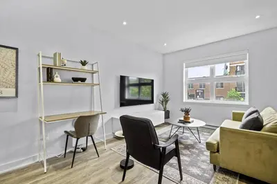 a living room with a couch and a table at Stylish 2 Bedroom Haven by Jean Talon Market in Montréal