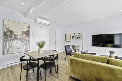 a living room with a couch and a table at Stylish 2 Bedroom Haven by Jean Talon Market in Montréal