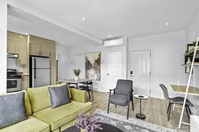 a living room with a couch and a table at Stylish 2 Bedroom Haven by Jean Talon Market in Montréal