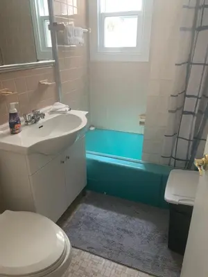 a bathroom with a sink and a toilet and a tub at Montréal Steps Downtown Private Rooms in Montréal