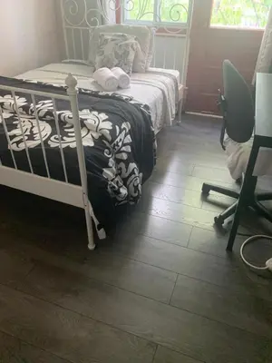 a bedroom with a bed and a wooden floor at Montréal Steps Downtown Private Rooms in Montréal