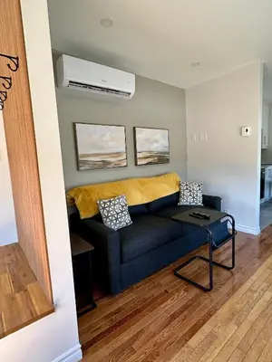 a living room with a couch and a table at Motel Le Refuge in Sherbrooke