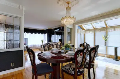 a dining room with a table and chairs and a chandelier at 4 Beds Entire House Wifi Parking in Laval-des-Rapides