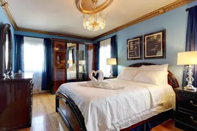 a bedroom with a bed with a swan on it at 4 Beds Entire House Wifi Parking in Laval-des-Rapides