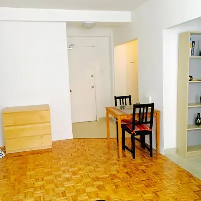 a dining room with a wooden table and two chairs at Stylish Montreal Apartment Comfortable Stay in the Golden Square Mile in Montréal