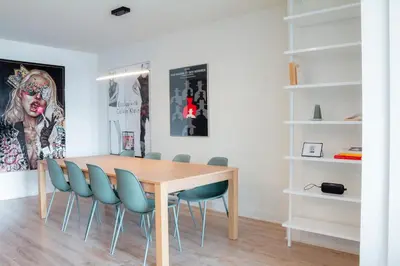a dining room with a wooden table and blue chairs at Penthouse with pool and parking in Montréal