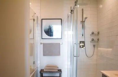 a bathroom with a shower with a glass door at Penthouse with pool and parking in Montréal