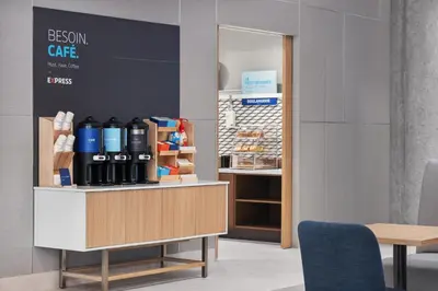 a room with a counter with bottles of wine at Holiday Inn Express Montreal Airport - St-Laurent by IHG in Montréal