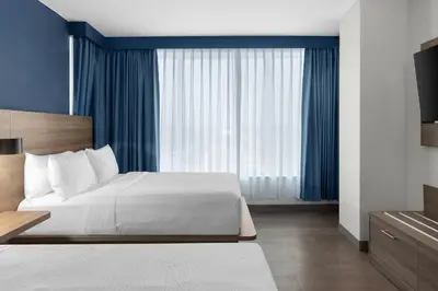 a bedroom with a bed and a large window at Holiday Inn Express Montreal Airport - St-Laurent by IHG in Montréal