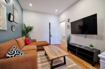 a living room with a couch and a flat screen tv at MTLVacationRentals- Le Clebard in Montréal