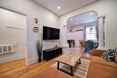 a living room with a couch and a table at MTLVacationRentals- Le Clebard in Montréal
