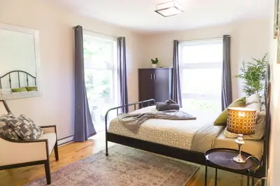 a bedroom with a bed and two windows at Archimede Panorama Spa in Austin