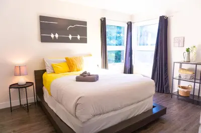 a bedroom with a bed with a teddy bear on it at Archimede Panorama Spa in Austin