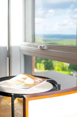 a table with a book on it in front of a window at Archimede Panorama Spa in Austin