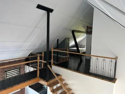 a room with a staircase in a building at La Mezzanine in Granby