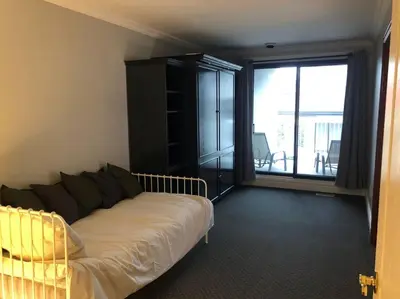 a living room with a couch and a large window at Spacious Lakefront Champlain lake with SPA in Venise-en-Québec