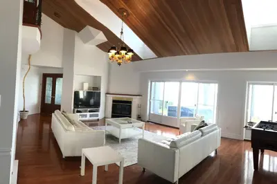 a living room with white furniture and a piano at Spacious Lakefront Champlain lake with SPA in Venise-en-Québec