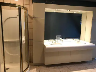 a bathroom with two sinks and a large mirror at Spacious Lakefront Champlain lake with SPA in Venise-en-Québec