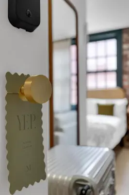a hospital room with a bed and a sign on the wall at The Mercer Boutique Hotel in Montréal