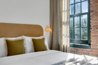 a bedroom with a bed and a window at The Mercer Boutique Hotel in Montréal