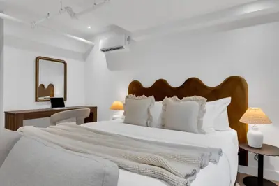 a white bedroom with a large white bed with white pillows at The Mercer Boutique Hotel in Montréal