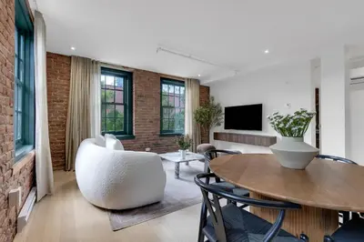 a living room with a table and chairs at The Mercer Boutique Hotel in Montréal