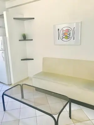 a room with a bench and a picture on the wall at Stylish Montreal Apartment Comfortable Stay in the Golden Square Mile in Montréal