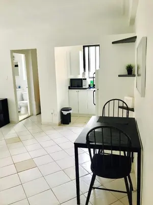a kitchen with a table and two chairs in a room at Stylish Montreal Apartment Comfortable Stay in the Golden Square Mile in Montréal
