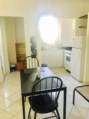 a kitchen with a table and two chairs and a table and a kitchen at Stylish Montreal Apartment Comfortable Stay in the Golden Square Mile in Montréal