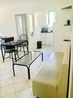 a living room with a couch and a table and chairs at Stylish Montreal Apartment Comfortable Stay in the Golden Square Mile in Montréal