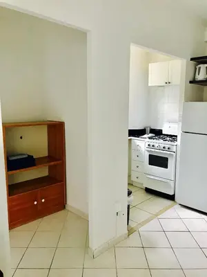 a kitchen with a stove and a white refrigerator at Stylish Montreal Apartment Comfortable Stay in the Golden Square Mile in Montréal