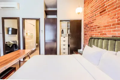 a bedroom with a bed and a brick wall at Self Check-In Boutique Hotel - Quartier latin - Room 101 in Montréal