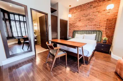 a bedroom with a bed and a brick wall at Self Check-In Boutique Hotel - Quartier latin - Room 101 in Montréal