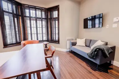 a living room with a couch and a table at Self Check-In Boutique Hotel - Quartier latin - Room 101 in Montréal