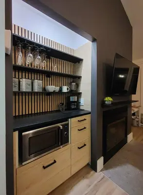 a kitchen with a microwave and a counter top at Chalet Aventure Orford in Orford