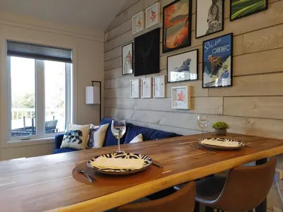 a dining room with a wooden table with two dishes on it at Chalet Aventure Orford in Orford