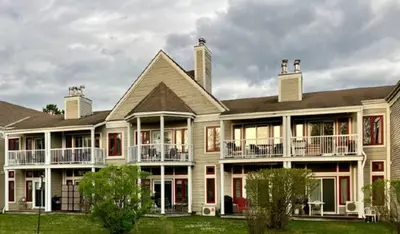 a large house with balconies on the front of it at Chalet Aventure Orford in Orford