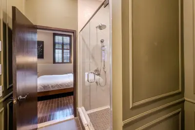 a bathroom with a walk in shower next to a glass door at Self Check-In Boutique Hotel - Quartier latin - Room 102 in Montréal