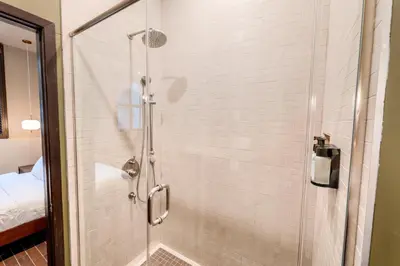 a shower with a glass door in a bathroom at Self Check-In Boutique Hotel - Quartier latin - Room 102 in Montréal