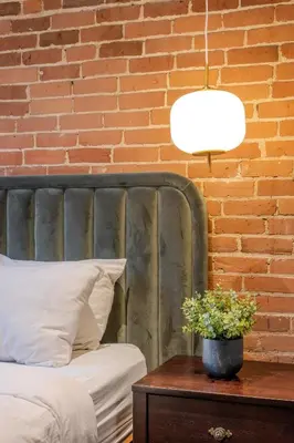 a bedroom with a bed and a brick wall at Self Check-In Boutique Hotel - Quartier latin - Room 102 in Montréal