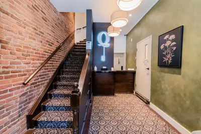 a staircase in a building with a brick wall at Self Check-In Boutique Hotel - Quartier latin - Room 103 in Montréal