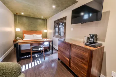 a room with a desk and a bed and a television at Self Check-In Boutique Hotel - Quartier latin - Room 103 in Montréal