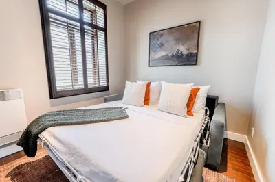 a bedroom with a large white bed with a window at Self Check-In Boutique Hotel - Quartier latin - Room 201 in Montréal