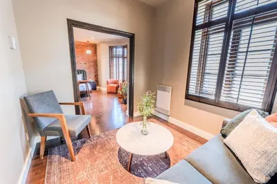 a living room with two chairs and a table at Self Check-In Boutique Hotel - Quartier latin - Room 201 in Montréal