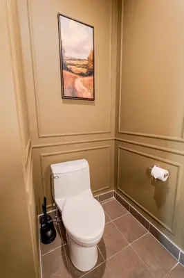 a bathroom with a toilet and a painting on the wall at Self Check-In Boutique Hotel - Quartier latin - Room 202 in Montréal