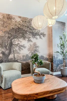 a living room with a table and two chairs and a mural at Self Check-In Boutique Hotel - Quartier latin - Room 202 in Montréal